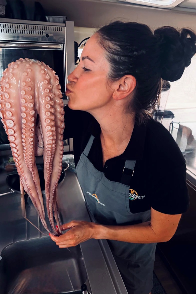 Allison Jacob working in a galley with fresh octopus