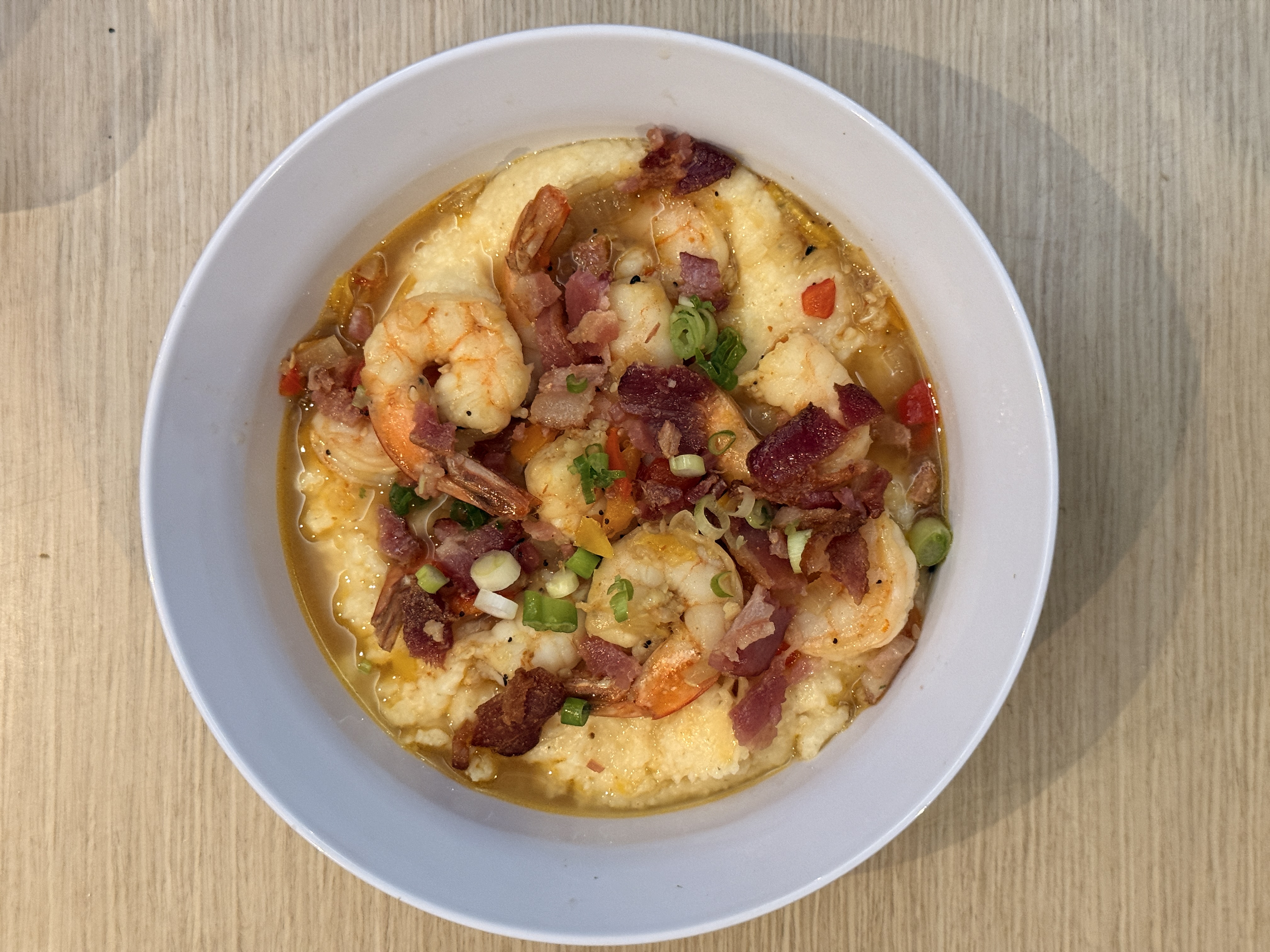 Shrimp and grits with bacon, peppers, and scallions