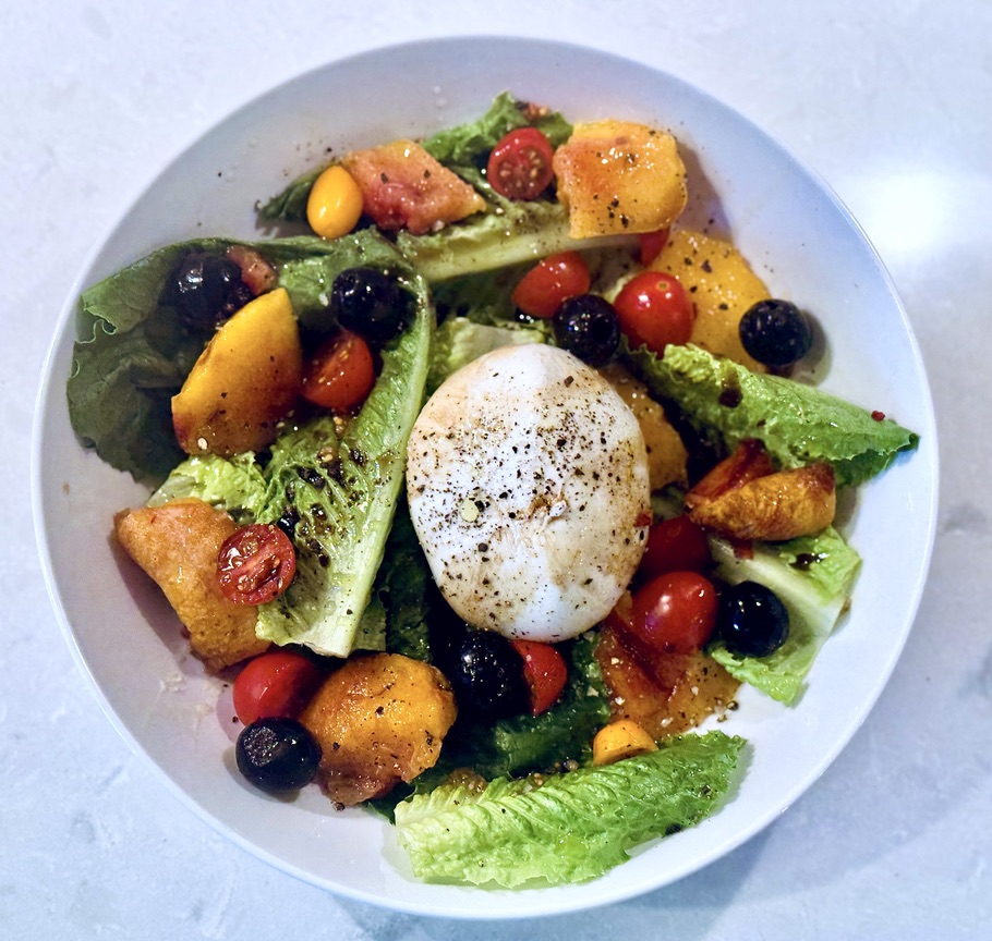 Burrata with grilled lettuce, tomatoes, blueberries, and stone fruit