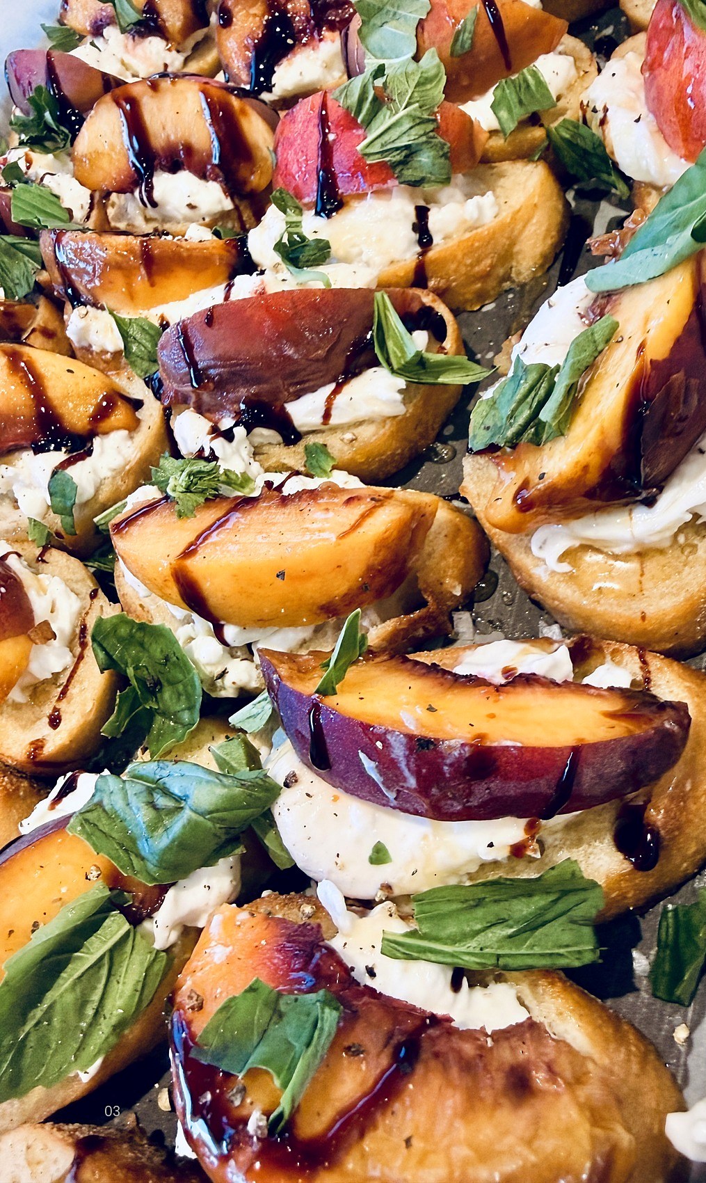 Grilled peach and burrata crostini with basil and balsamic